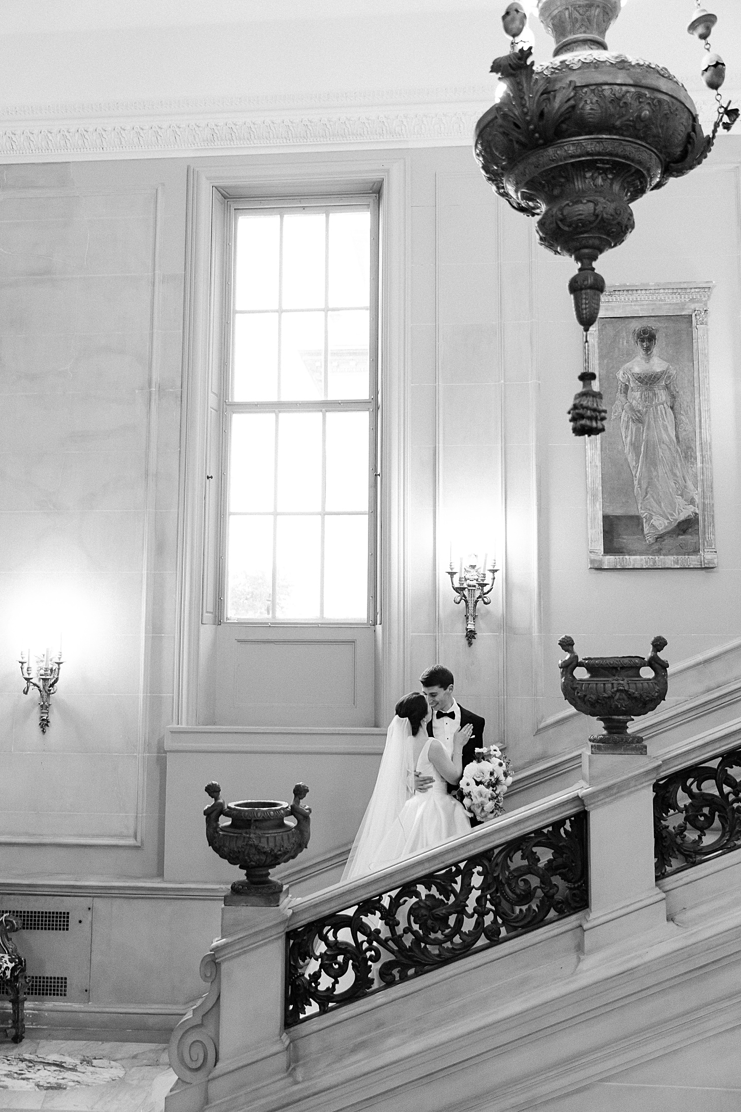 Kissing on stairs at Anderson House Wedding by Sarah Bradshaw