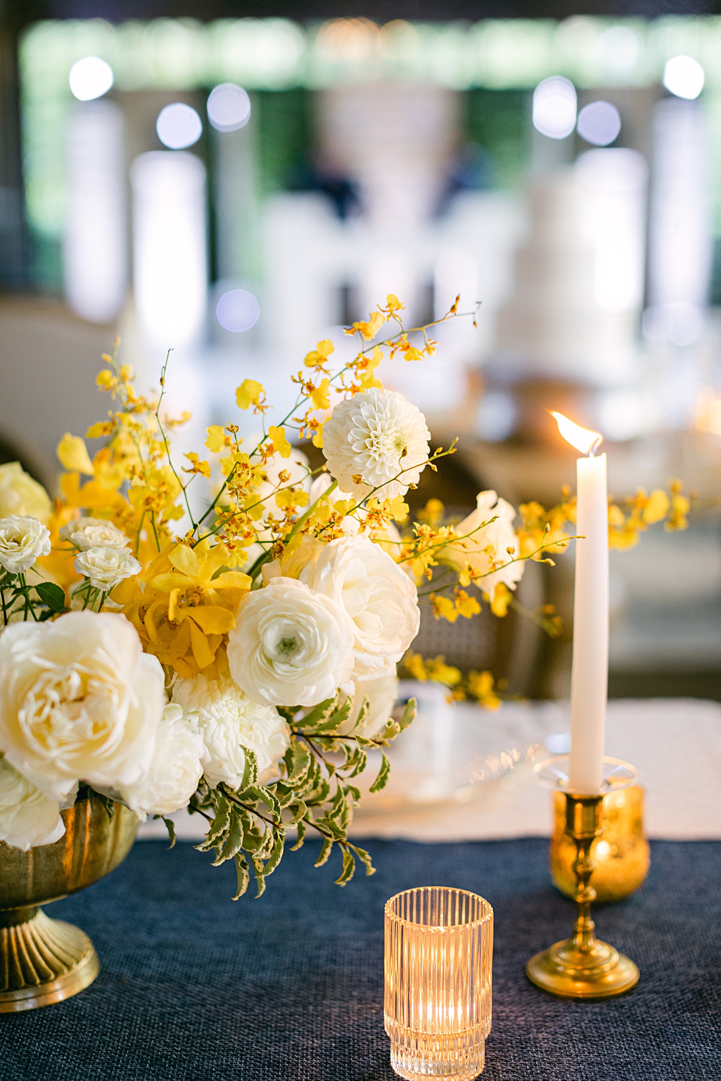 Organic yellow and white floral centerpiece by Kate Asire  at The Farm at Old Edwards Inn wedding by Sarah Bradshaw Photography