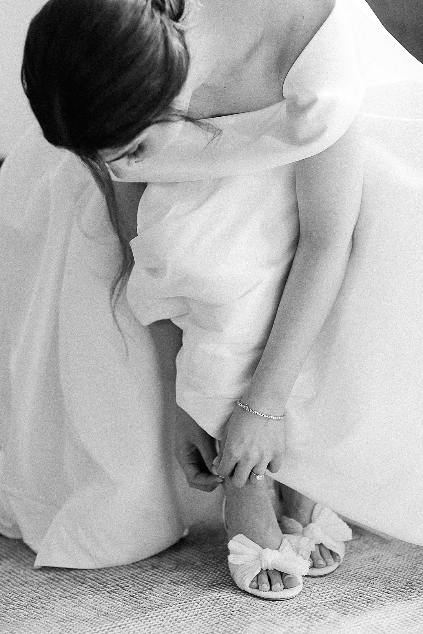 Bride putting on Loeffler Randall shoes at The Clifton Charlottesville by Sarah Bradshaw Photography