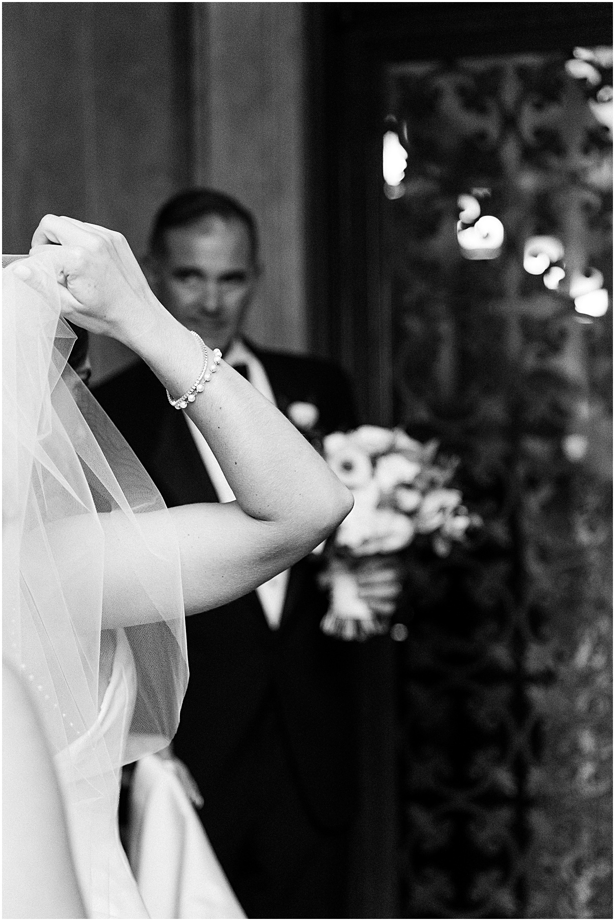 Bride adjusts her veil while her father looks on at Our Lady of Lourdes at Georgetown Prep wedding by Sarah Bradshaw