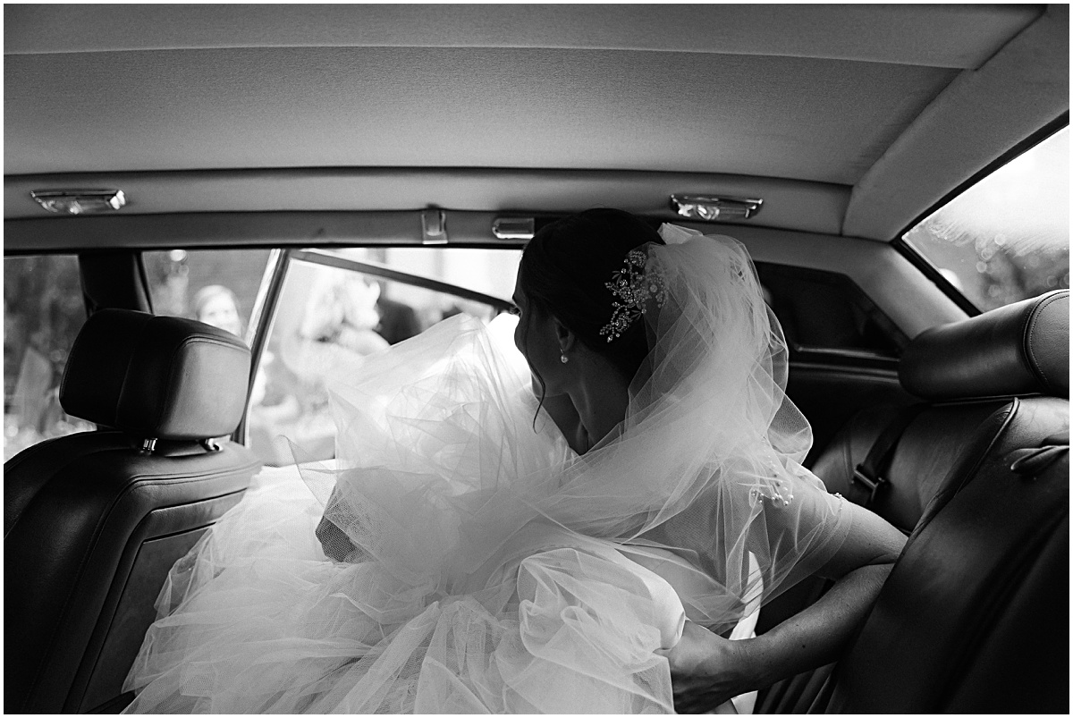 Bride getting into limo at Congressional Country Club wedding by Sarah Bradshaw