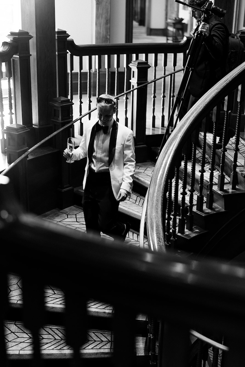 Candid portrait of groom on a staircase. Elegant wedding at the Ritz-Carlton Lake Oconee in Georgia. Sarah Bradshaw Photography.