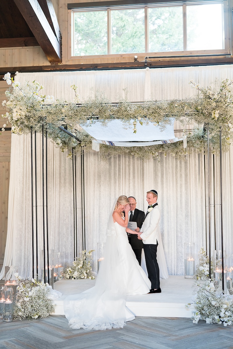 Bride and groom laugh while exchanging vows. Elegant wedding at the Ritz-Carlton Lake Oconee in Georgia. Sarah Bradshaw Photography.