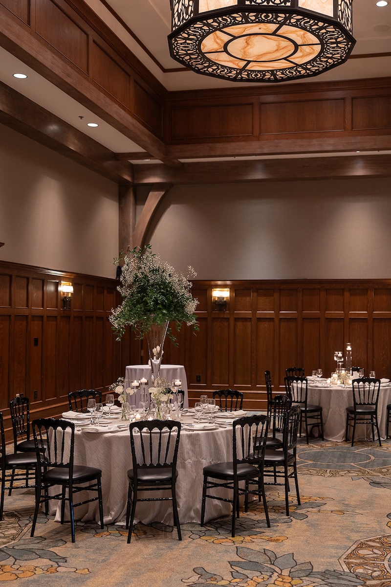 Simple, modern wedding reception decor. Round tables, black chairs, candle centerpieces. Elegant wedding at the Ritz-Carlton Lake Oconee in Georgia. Sarah Bradshaw Photography.
