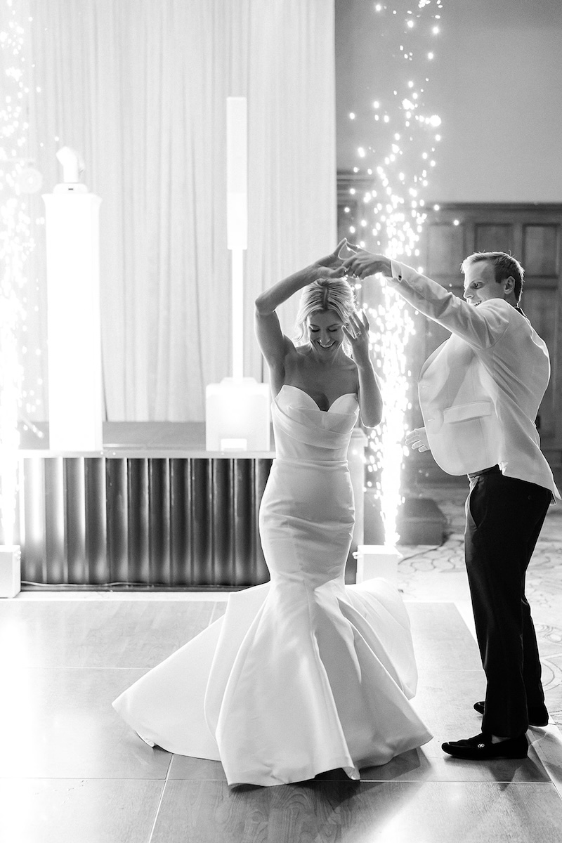 First dance of bride and groom with sparkler fireworks. Elegant wedding at the Ritz-Carlton Lake Oconee in Georgia. Sarah Bradshaw Photography.