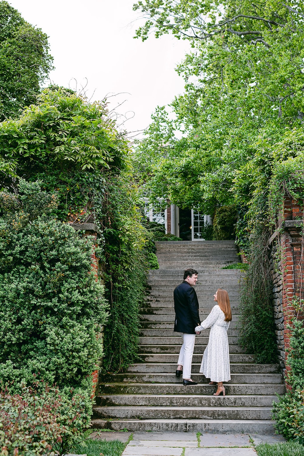 couple on garden staircase. Spring wedding engagement photo session. Sarah Bradshaw Photography.