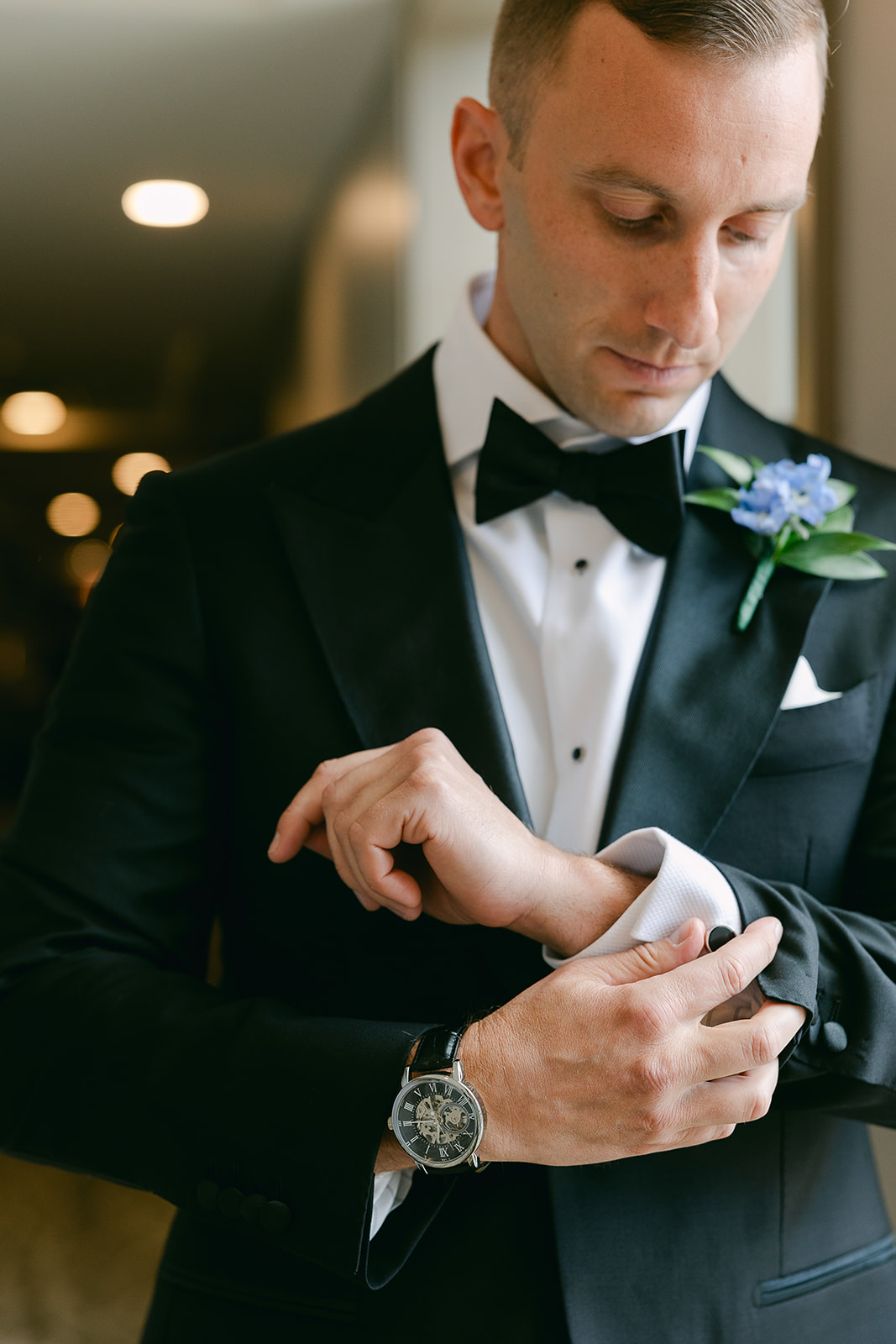 Groom putting on cufflinks on wedding morning. high end elopement wedding in tampa florida. sarah bradshaw photography.