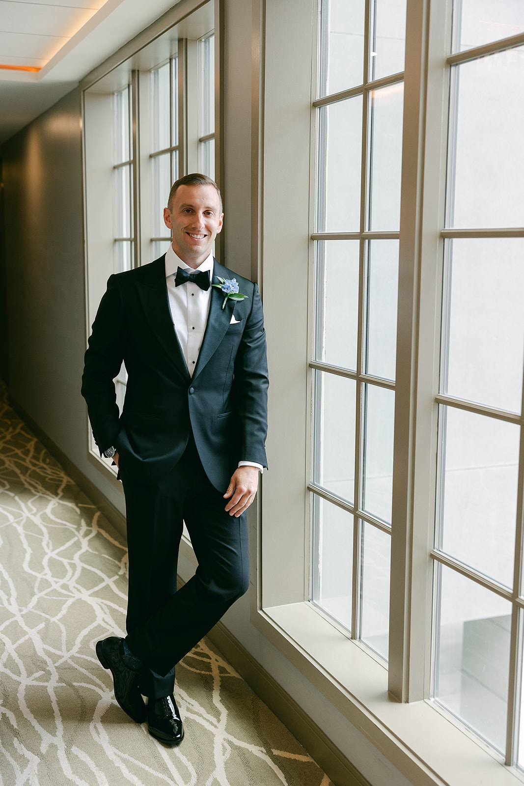 Groom in stylish tuxedo and blue Boutonniere. high end elopement wedding in tampa florida. sarah bradshaw photography.