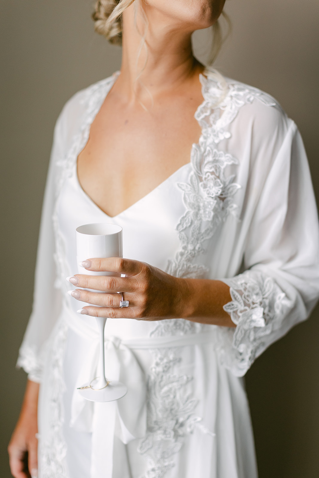 bride in lace bridal robe with champagne glass. high end elopement wedding in tampa florida. sarah bradshaw photography.