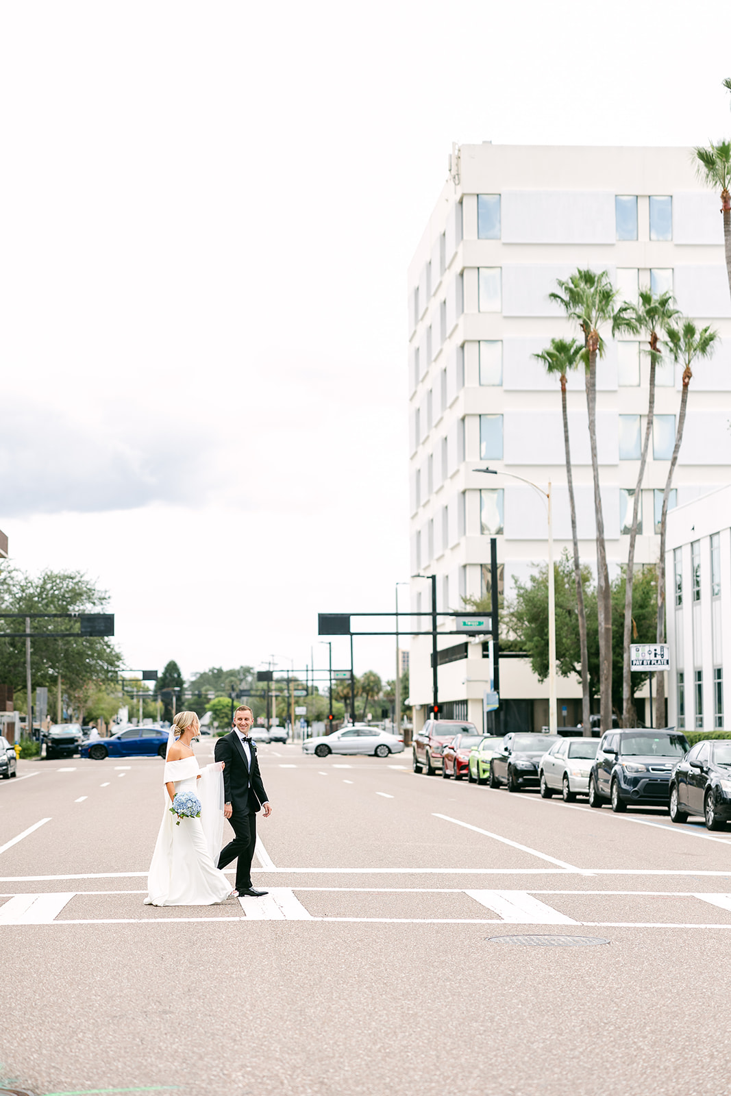 Bride and groom portrait crossing street. high end elopement wedding in tampa florida. sarah bradshaw photography.