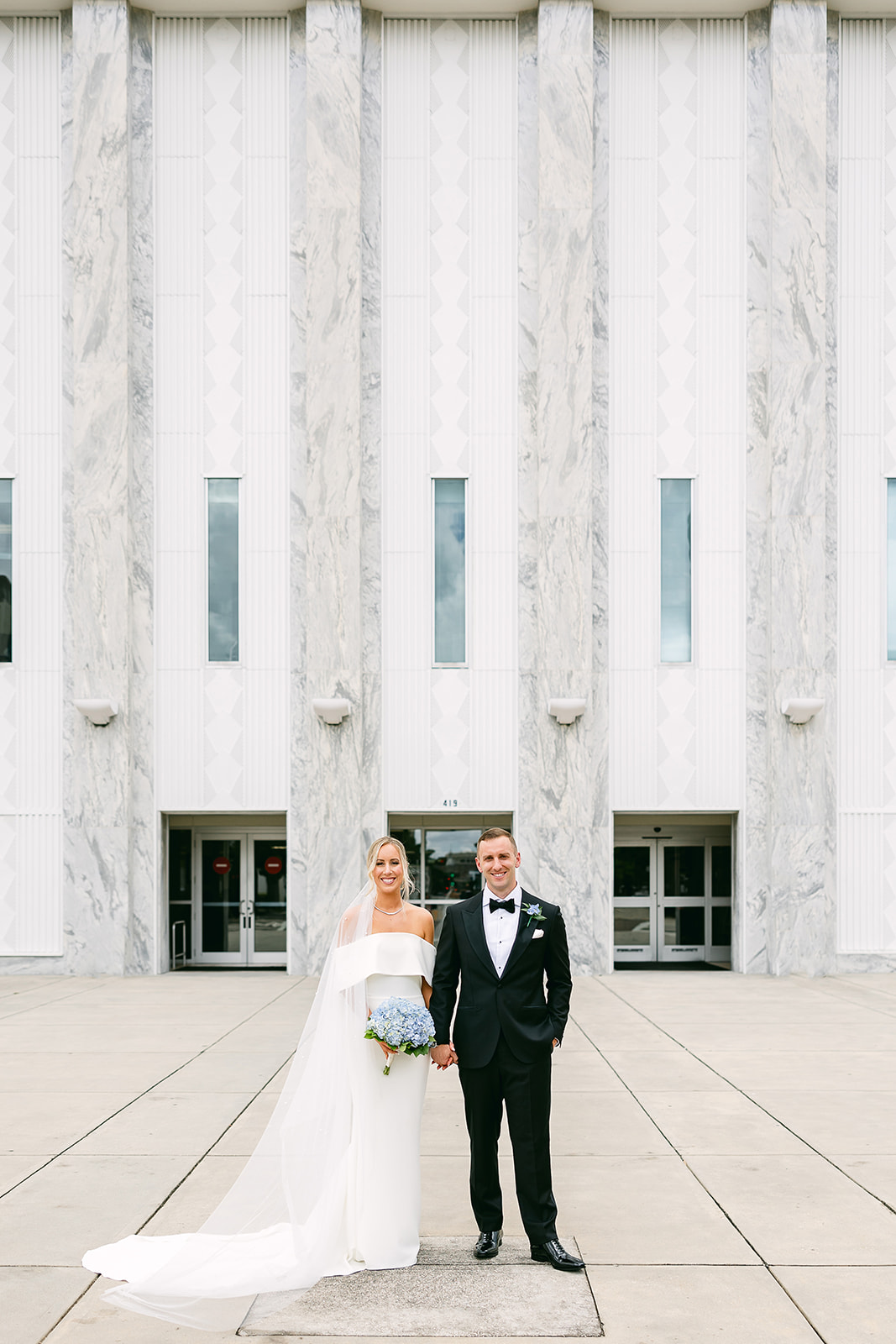 bride and groom pose outside courthouse. high end elopement wedding in tampa florida. sarah bradshaw photography.