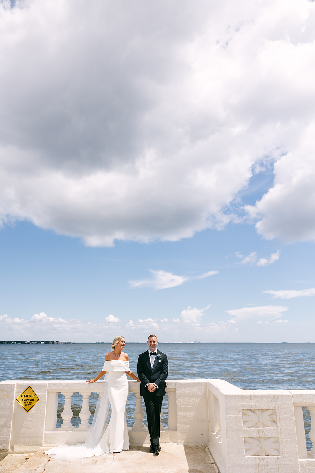 bride and groom pose by the ocean. high end elopement wedding in tampa florida. sarah bradshaw photography.