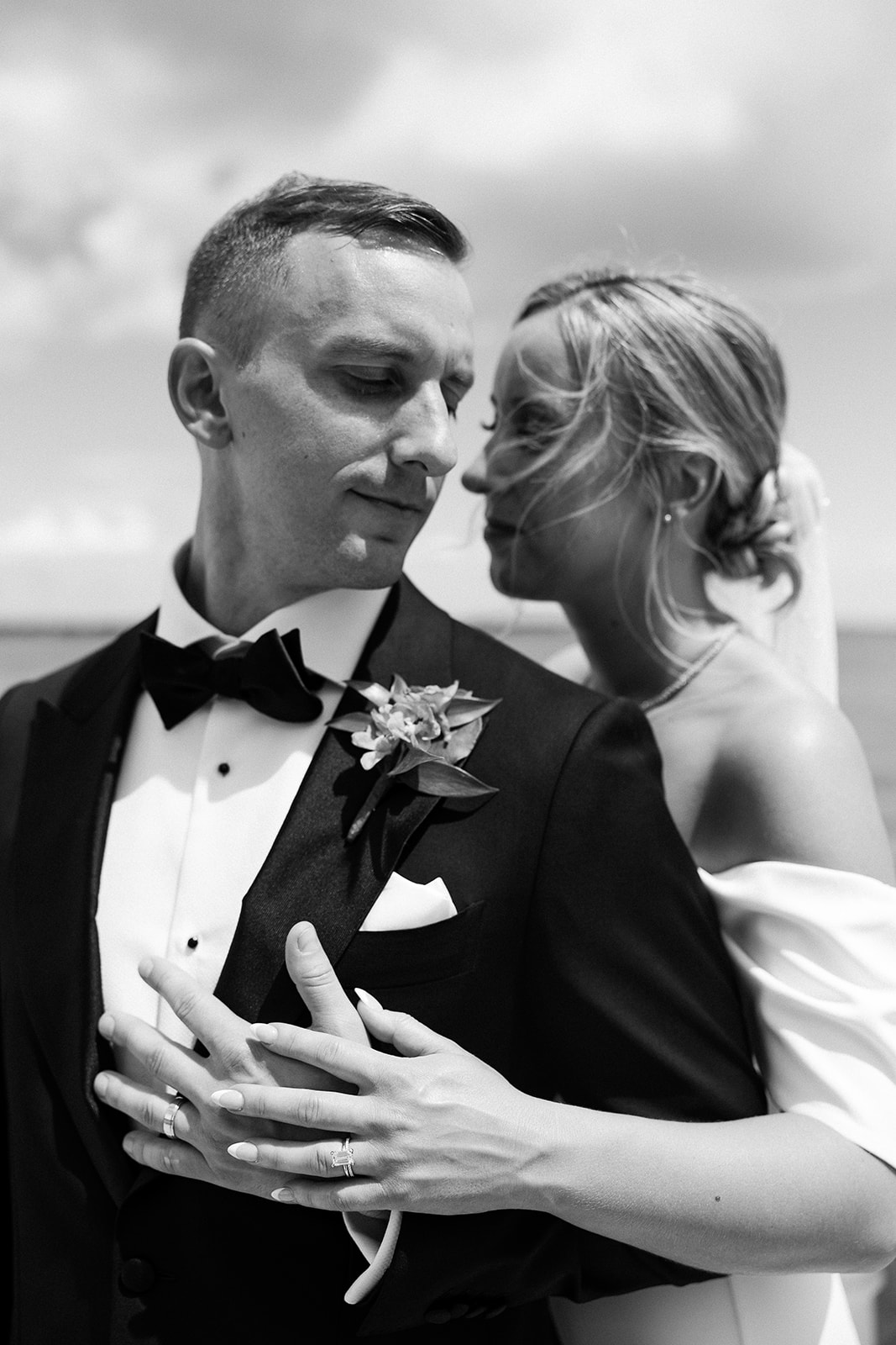 black and white wedding portrait, bride hug groom from behind. high end elopement wedding in tampa florida. sarah bradshaw photography.