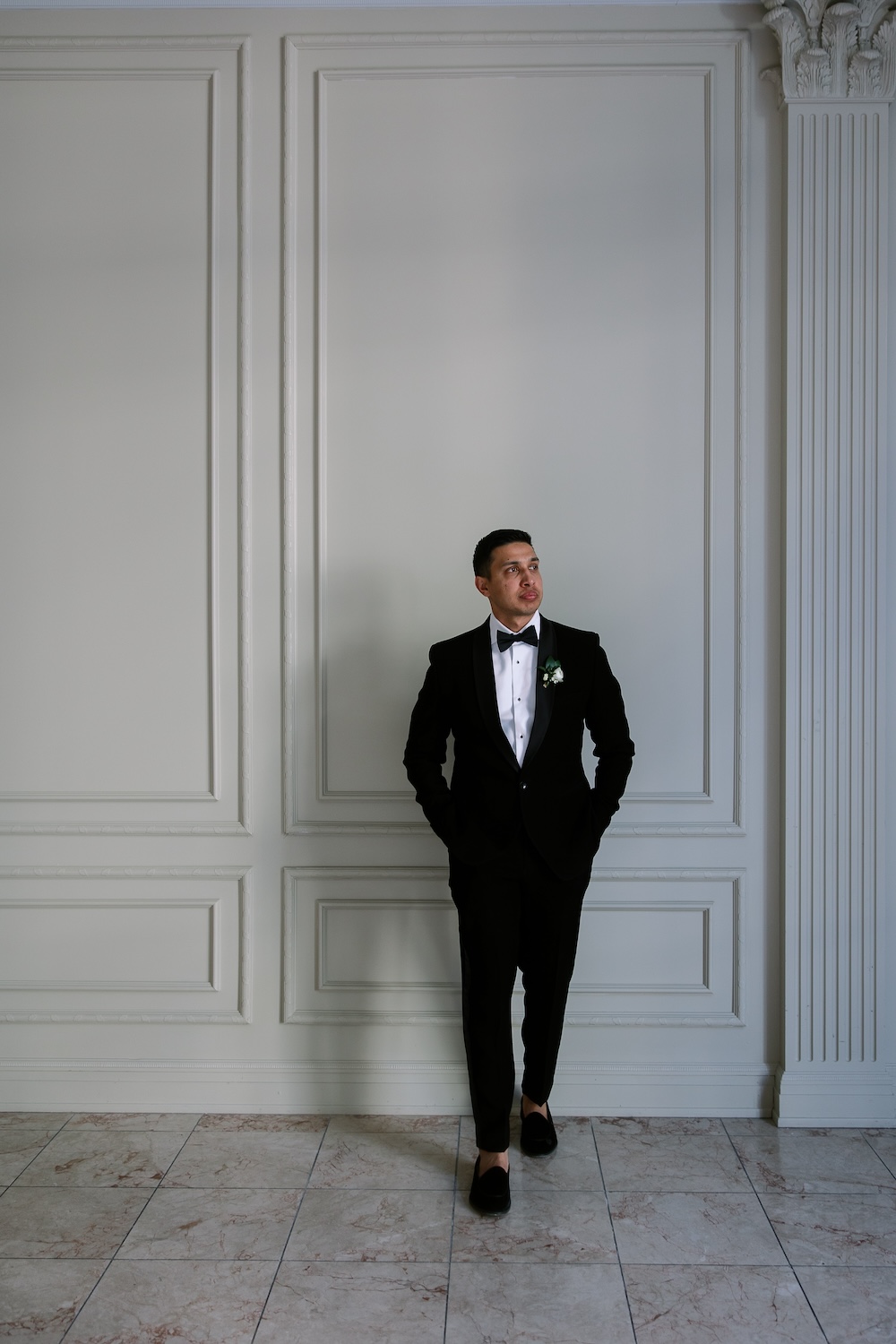 Formal posed portrait of groom in tuxedo in museum room. Modern Washington DC wedding at National Museum of Women in the Arts. Sarah Bradshaw Photography.