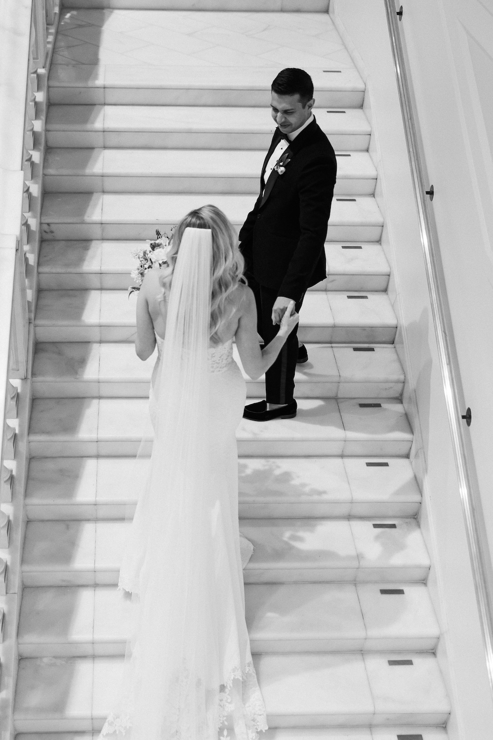 bride and groom walking up staircase. Modern Washington DC wedding at National Museum of Women in the Arts. Sarah Bradshaw Photography.