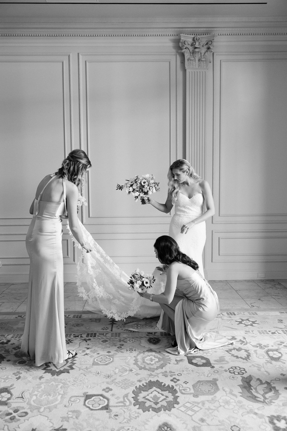 Bridesmaids help bride with wedding veil. Modern Washington DC wedding at National Museum of Women in the Arts. Sarah Bradshaw Photography.