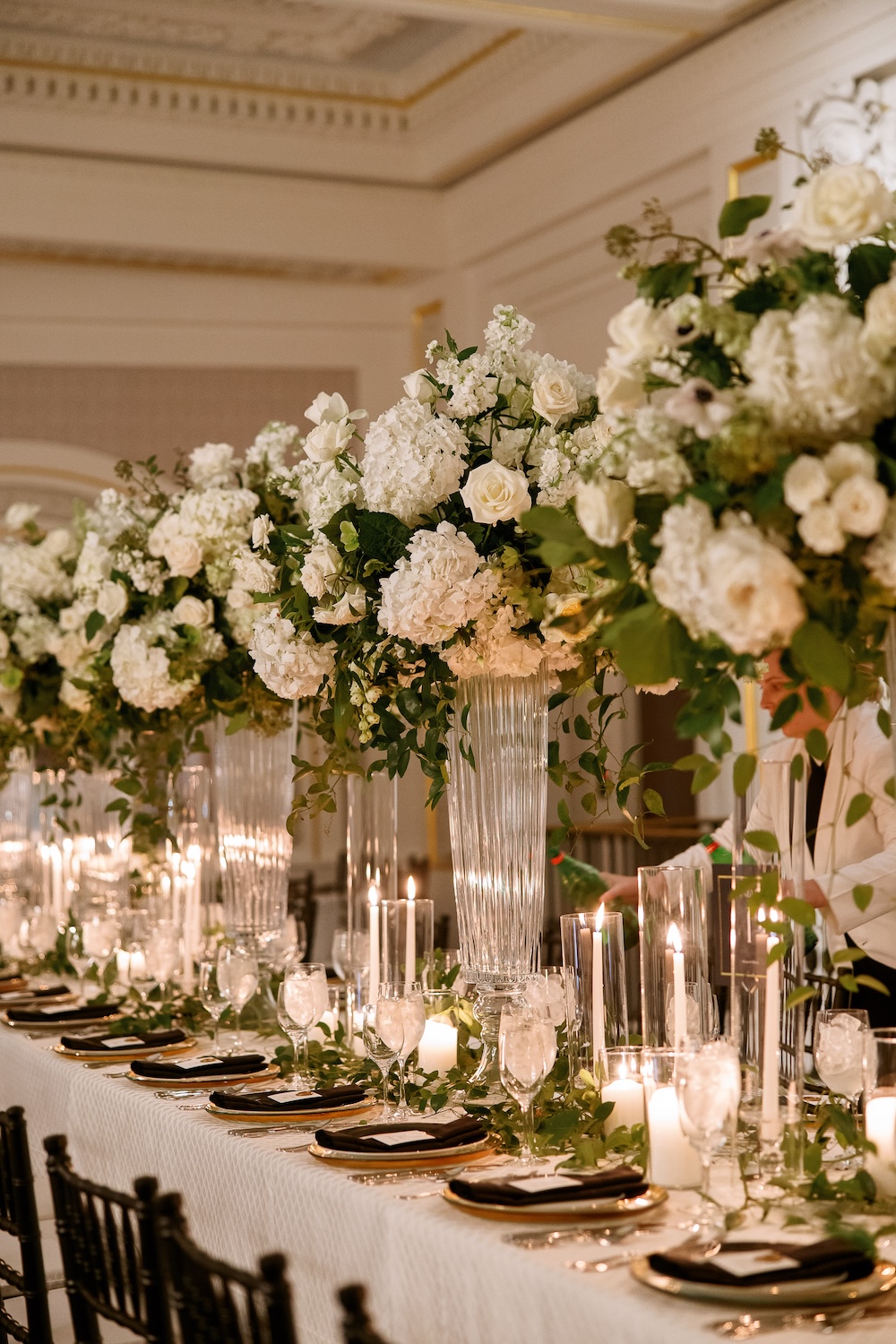 Tall lush floral centerpieces, white and green, candles. Elegant modern decor. Modern Washington DC wedding at National Museum of Women in the Arts. Sarah Bradshaw Photography.