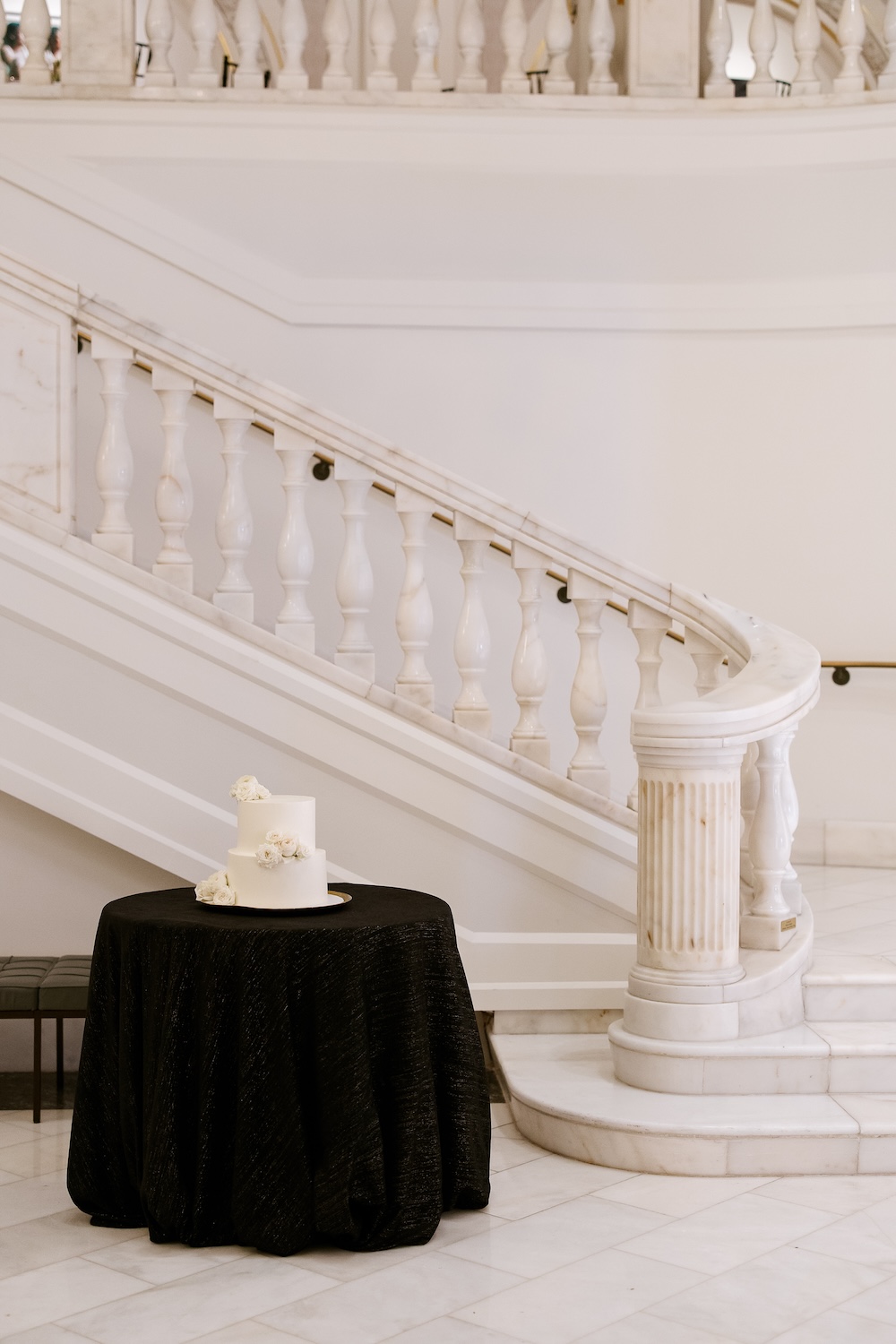 Simple modern wedding cake, two tiers, flowers on cake. Modern Washington DC wedding at National Museum of Women in the Arts. Sarah Bradshaw Photography.