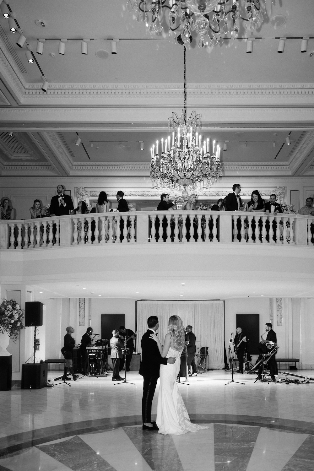 Bride and groom share first dance while guests watch on balcony. Modern Washington DC wedding at National Museum of Women in the Arts. Sarah Bradshaw Photography.