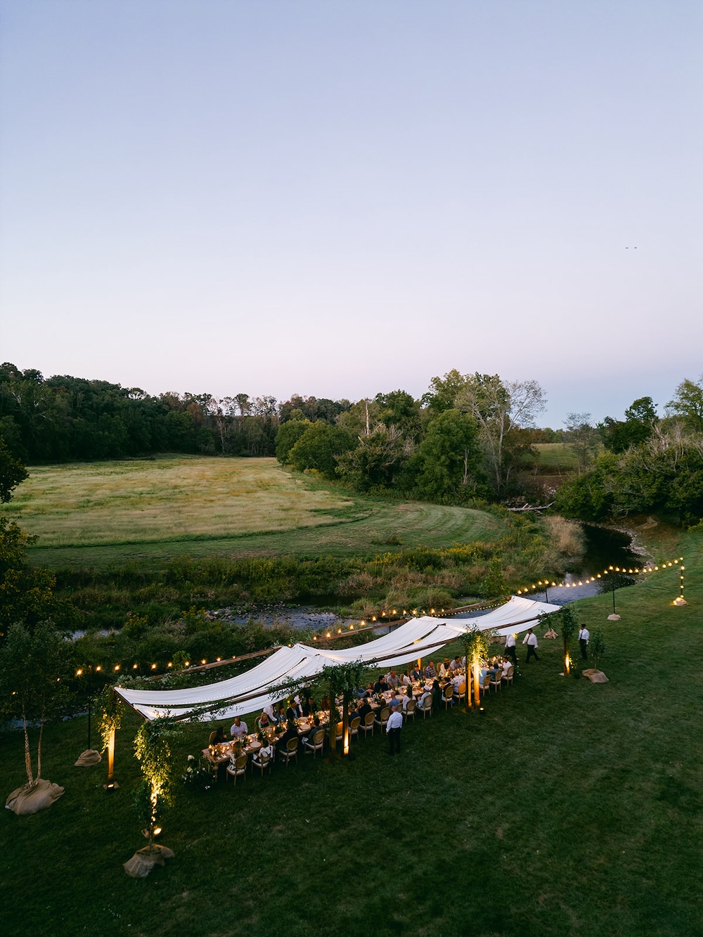Ariel photograph of rustic chic tented alfresco dinner. Milestone birthday party celebration weekend in Middleburg, Virginia. Sarah Bradshaw Photography.