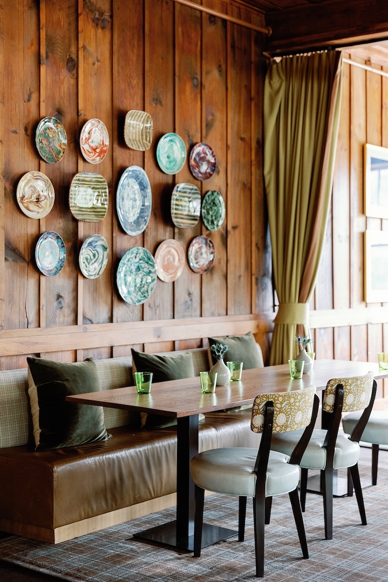 Chic mountain inn dining space, plates on wall. High Hampton in North Carolina, Sarah Bradshaw Photography