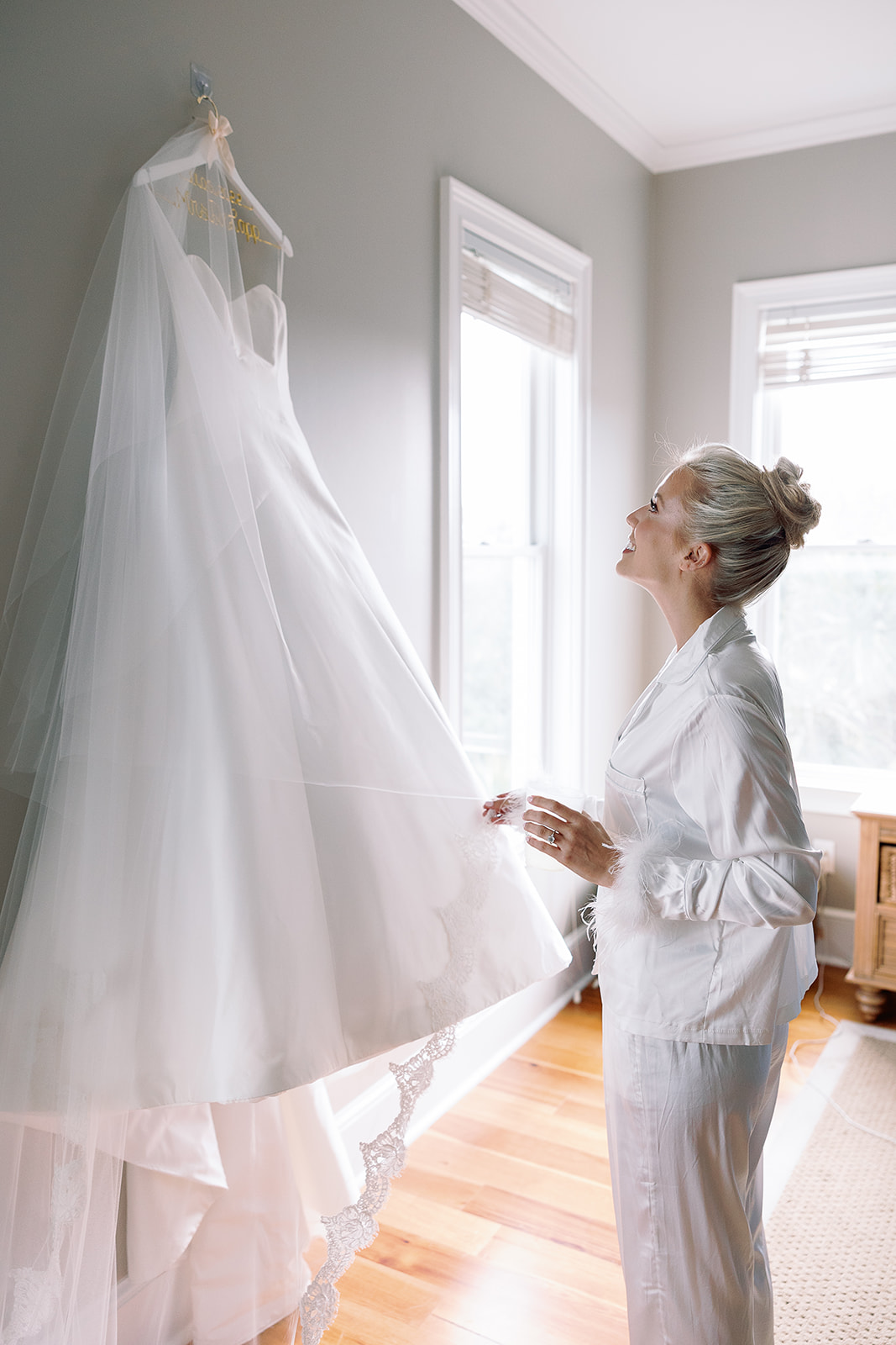 Bride admires her timeless wedding dress. Classic Black Tie wedding in Georgetown, SC. Sarah Bradshaw Photography