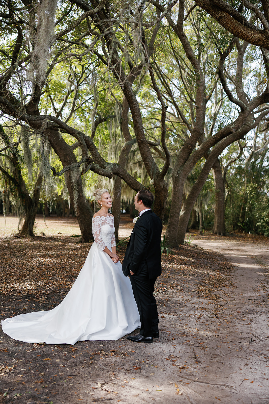 Bride and groom first look wedding reveal in grove of live oak trees. Classic Black Tie wedding in Georgetown, SC. Sarah Bradshaw Photography