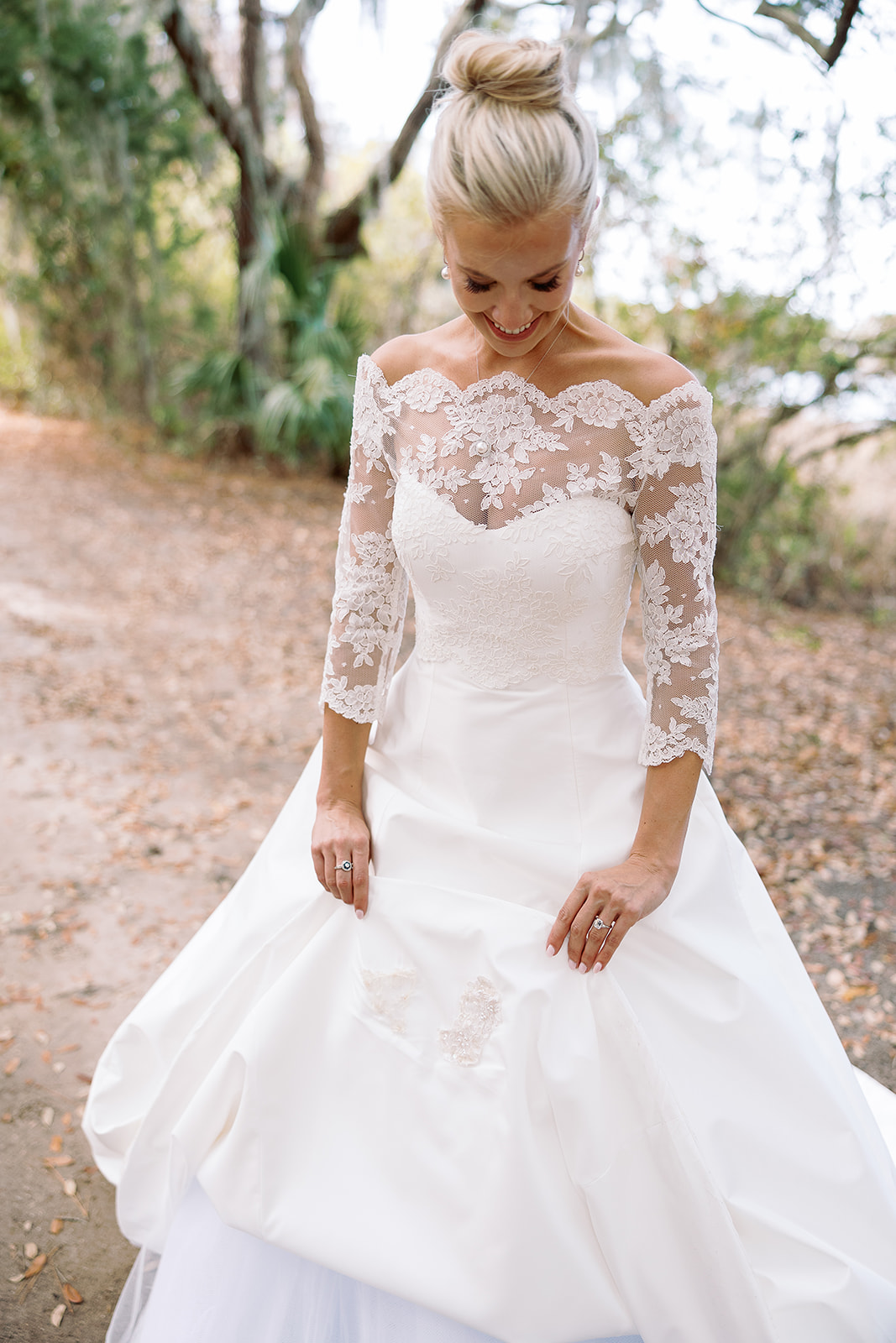 Bride shows off wedding monogram on underside of wedding dress. Classic Black Tie wedding in Georgetown, SC. Sarah Bradshaw Photography