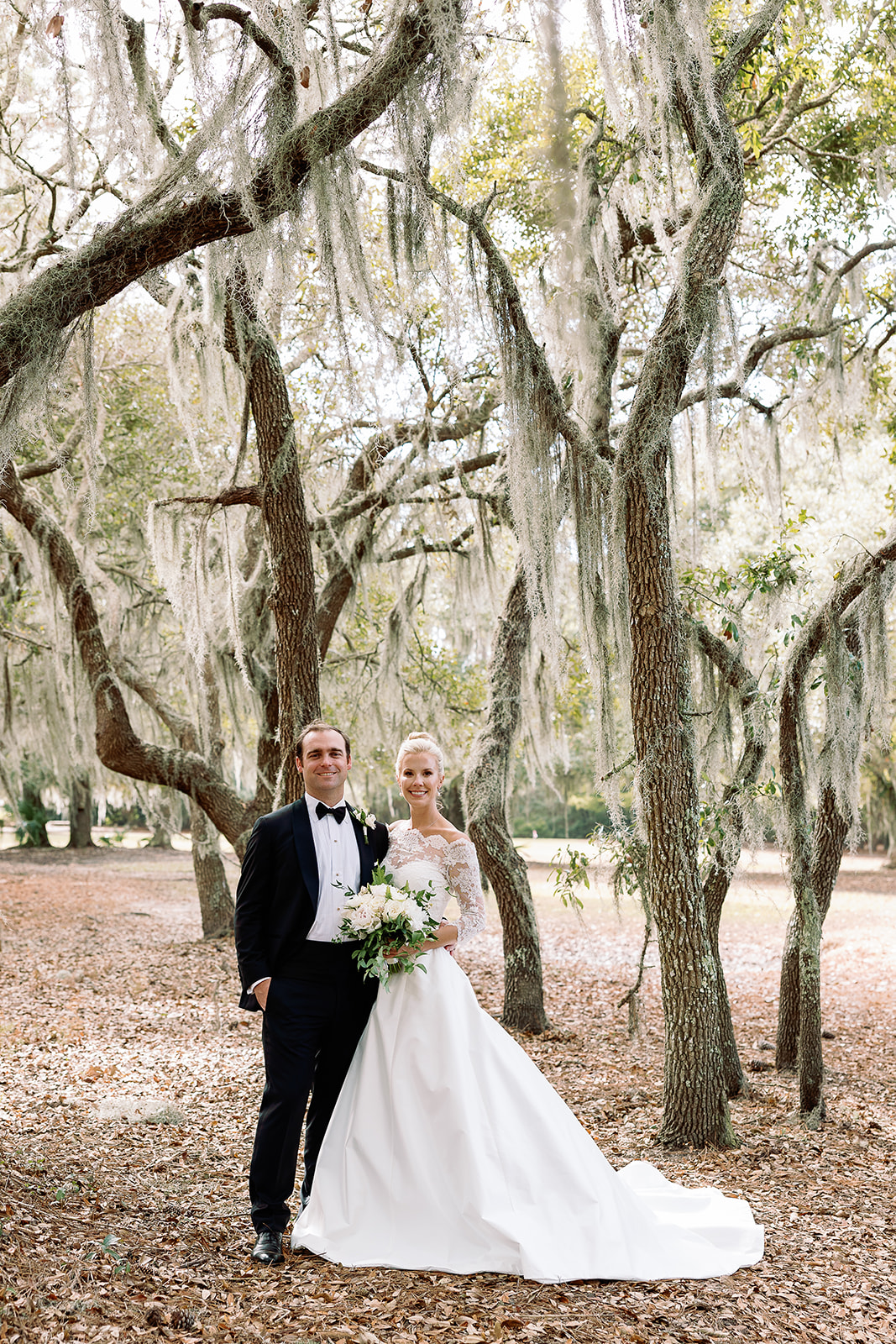 traditional wedding day portrait posing, bride and groom in live oak tree grove. Classic Black Tie wedding in Georgetown, SC. Sarah Bradshaw Photography