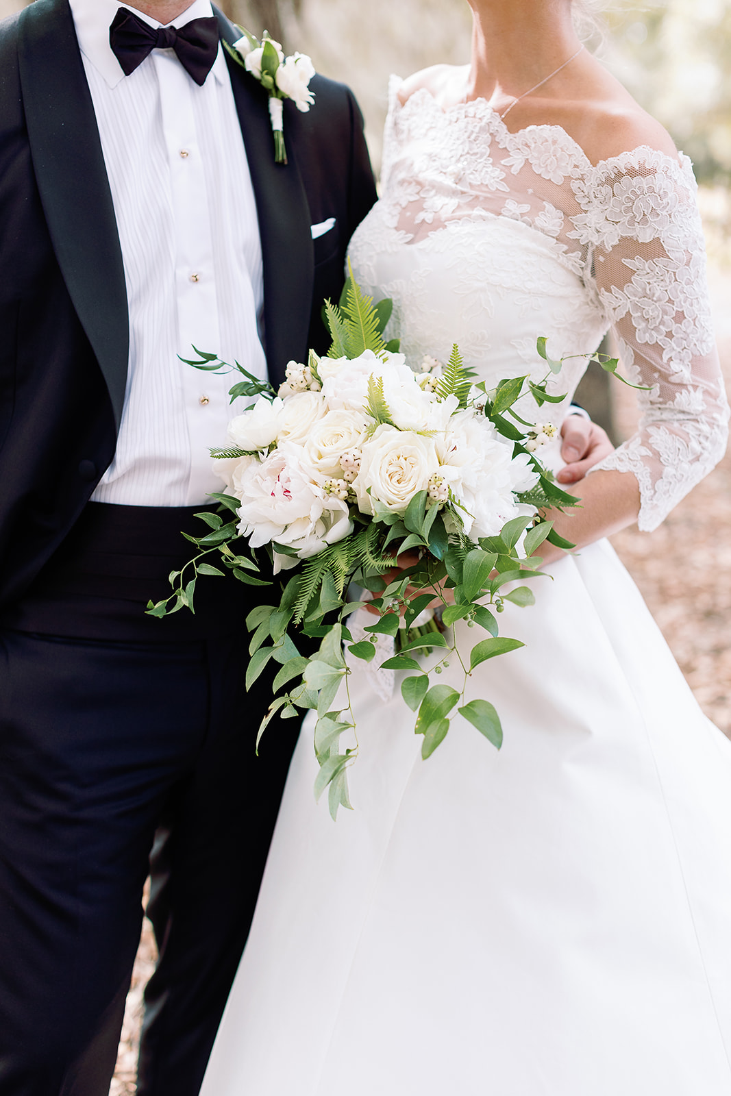 Close up portrait of wedding day attire, white bridal bouquet. Classic Black Tie wedding in Georgetown, SC. Sarah Bradshaw Photography