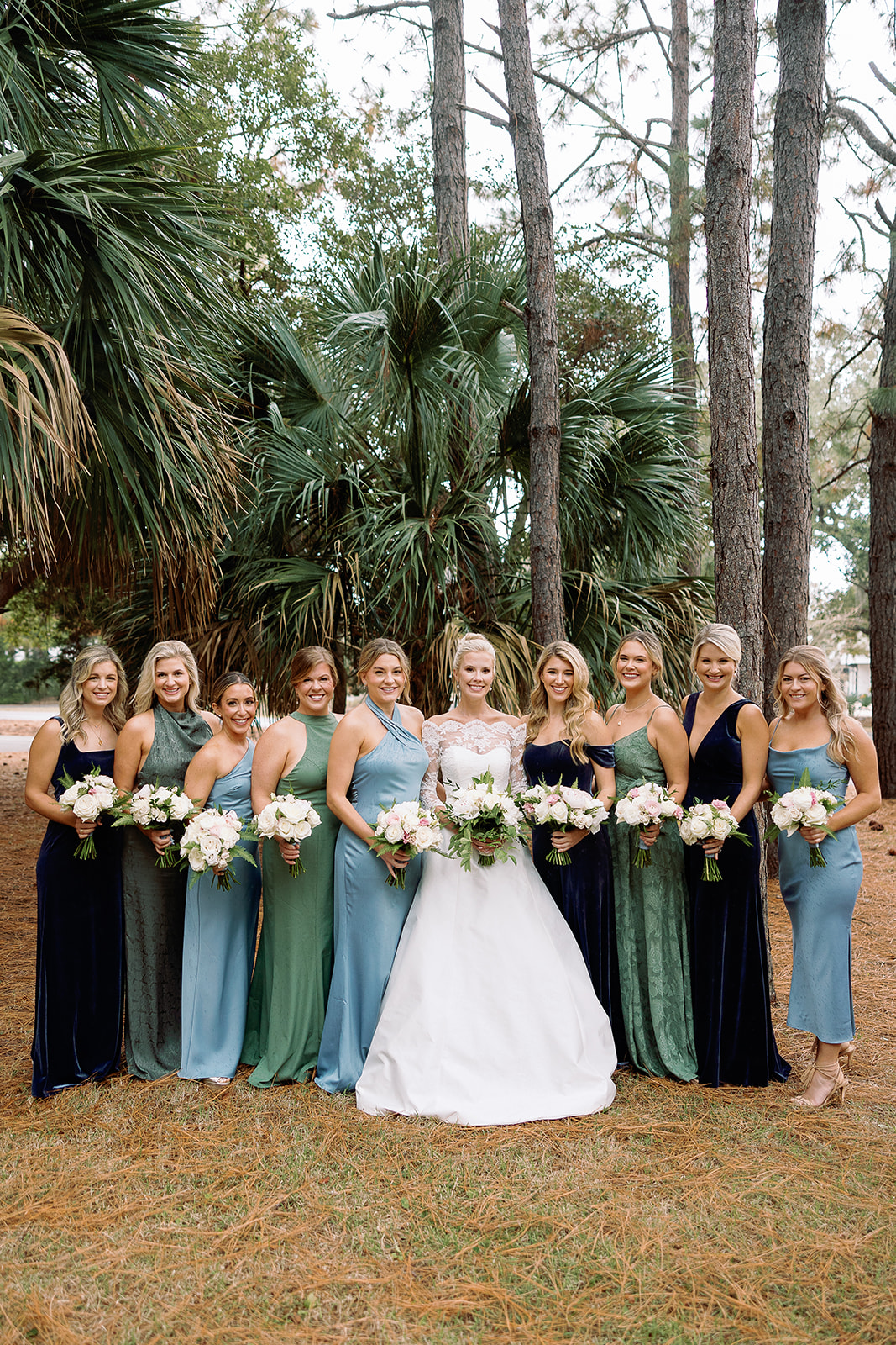 Bride and bridesmaids portrait, bridesmaids in shades of blue and green. Classic Black Tie wedding in Georgetown, SC. Sarah Bradshaw Photography