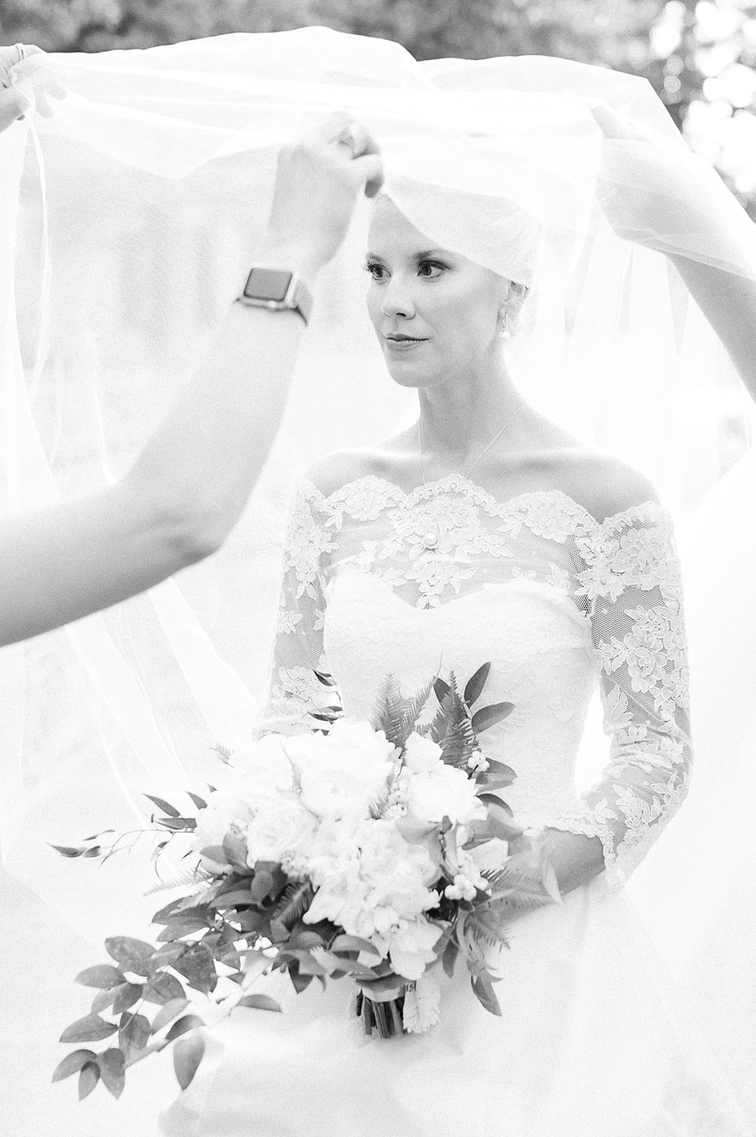 Black and white portrait of bride being veiled before wedding ceremony. Classic Black Tie wedding in Georgetown, SC. Sarah Bradshaw Photography