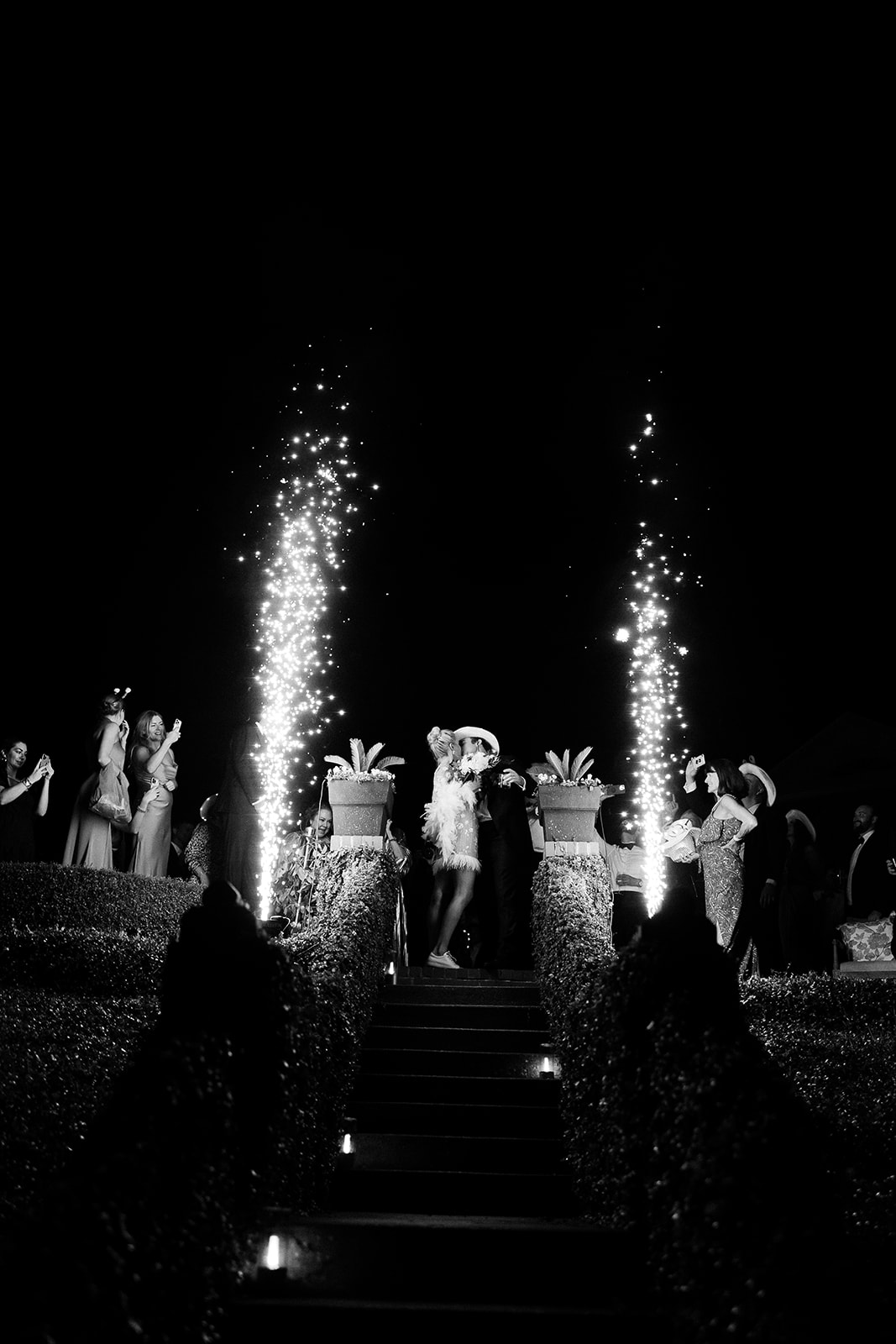 Bride and groom kiss during sparklers at wedding exit. Classic Black Tie wedding in Georgetown, SC. Sarah Bradshaw Photography