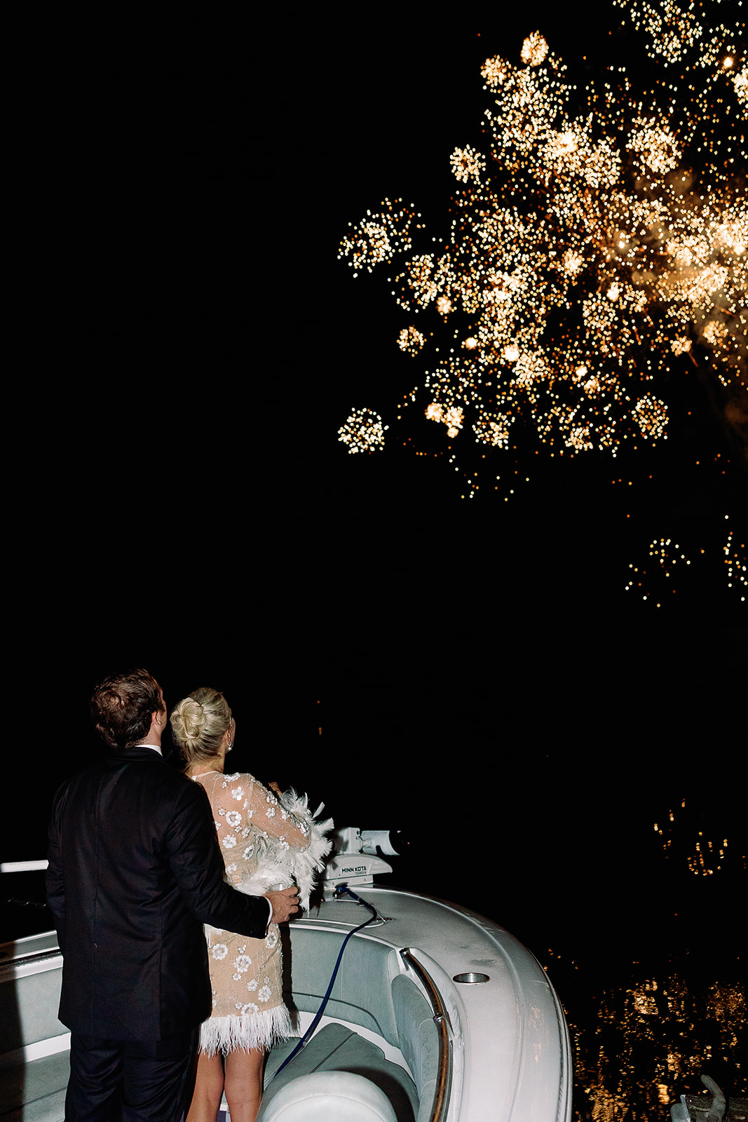 Bride and groom watch fireworks on a boat to end wedding reception. Classic Black Tie wedding in Georgetown, SC. Sarah Bradshaw Photography