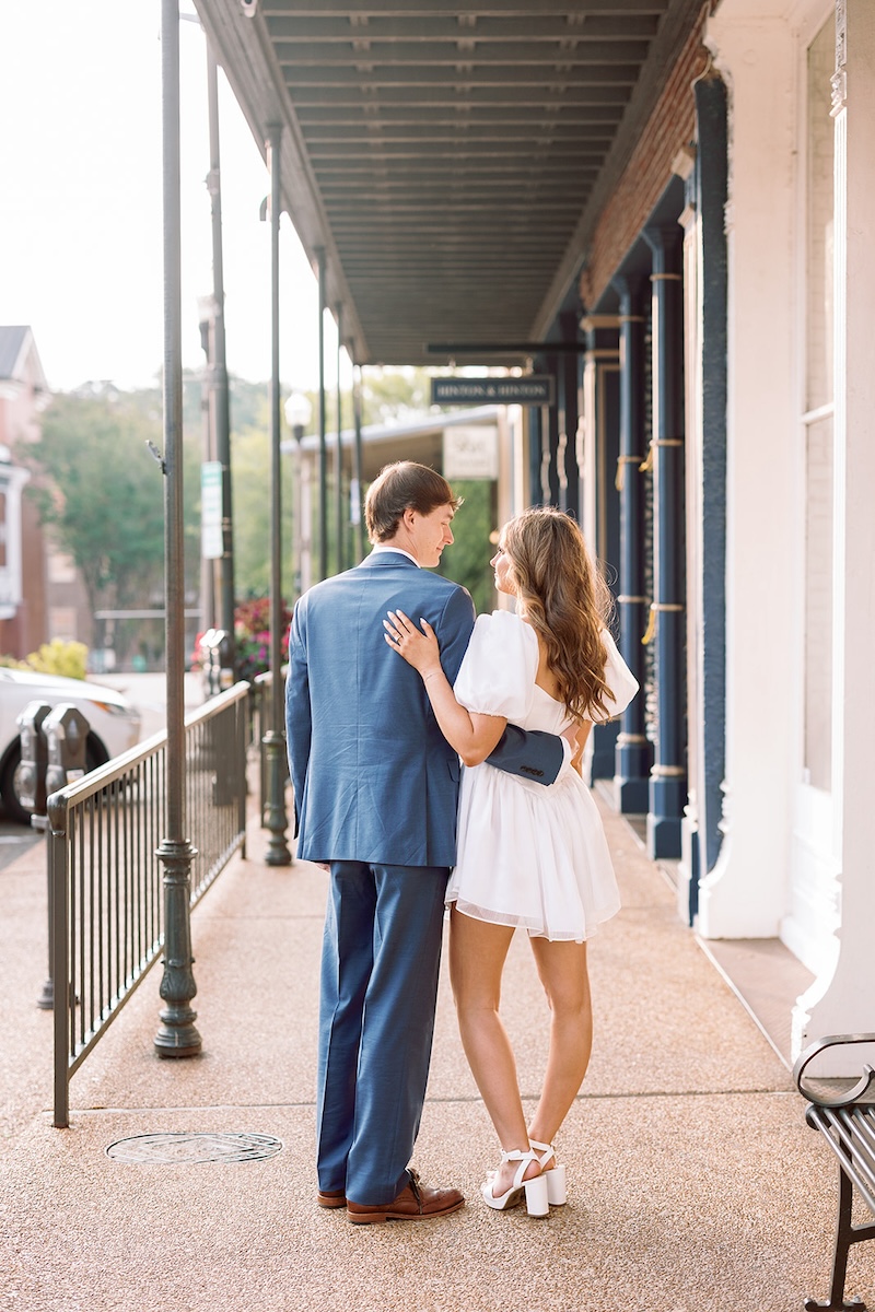 portrait of couple walking away. chic little white dress. southern wedding engagement session, sarah bradshaw photography.