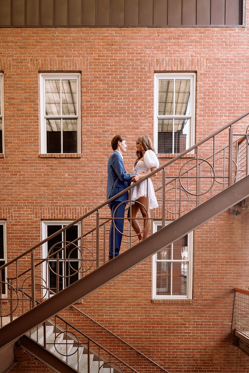 creative portrait of couple on iron staircase. southern wedding engagement session, sarah bradshaw photography.