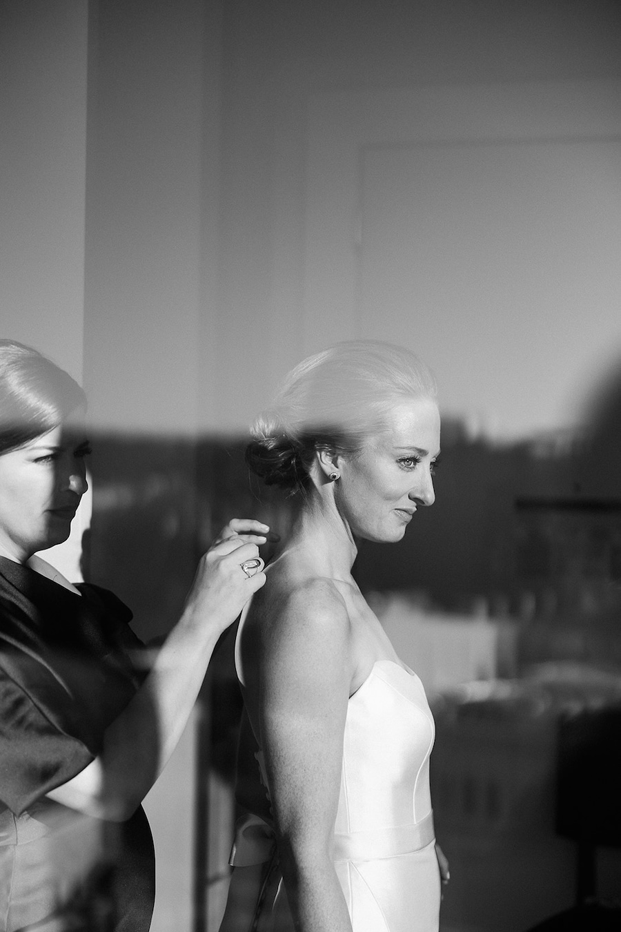 maid of honor puts necklace on bride. Timeless winter wedding, anderson house, washington dc, sarah bradshaw photography.