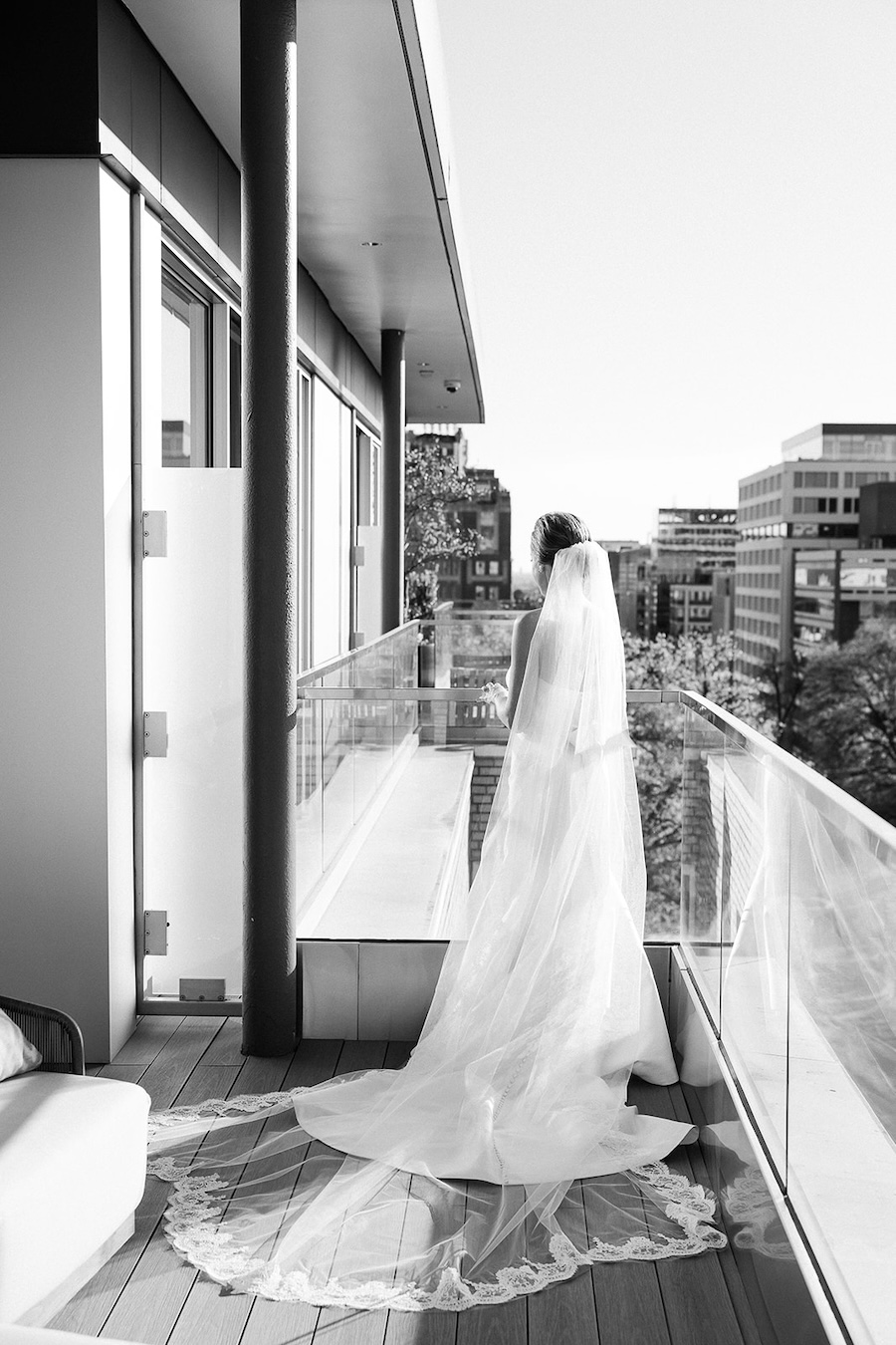 black and white photo of bride on balcony. Timeless winter wedding, anderson house, washington dc, sarah bradshaw photography.