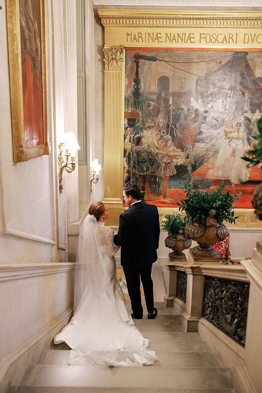 bride and groom walking down grand staircase. Timeless winter wedding, anderson house, washington dc, sarah bradshaw photography.