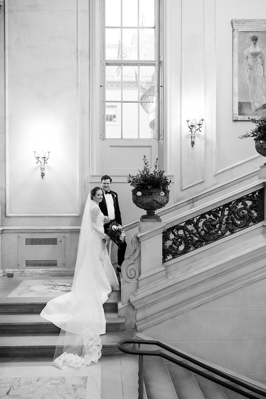 bride and groom pose on elegant staircase. blacktie wedding. Timeless winter wedding, anderson house, washington dc, sarah bradshaw photography.