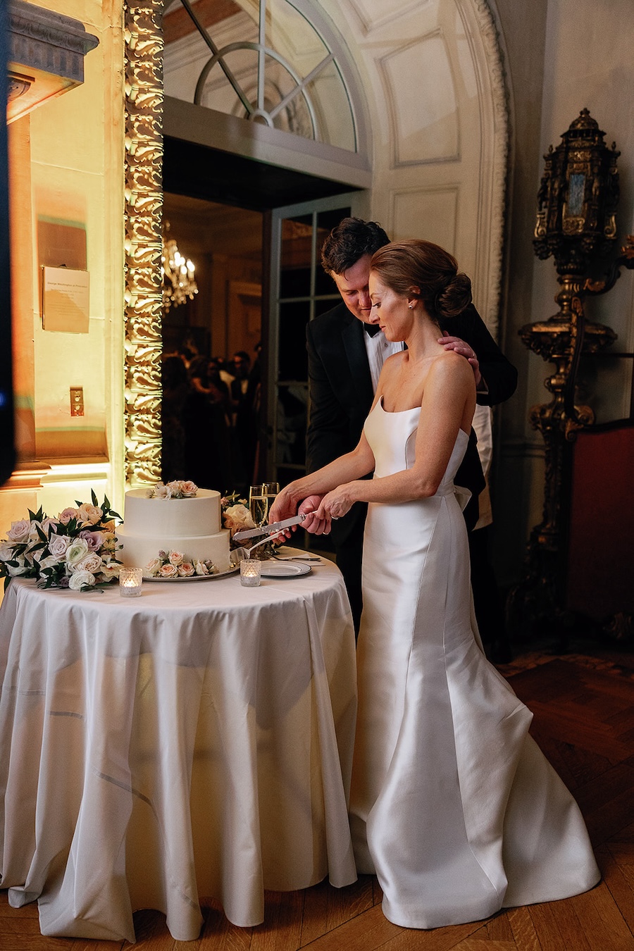 bride and groom cut small wedding cake. Timeless winter wedding, anderson house, washington dc, sarah bradshaw photography.