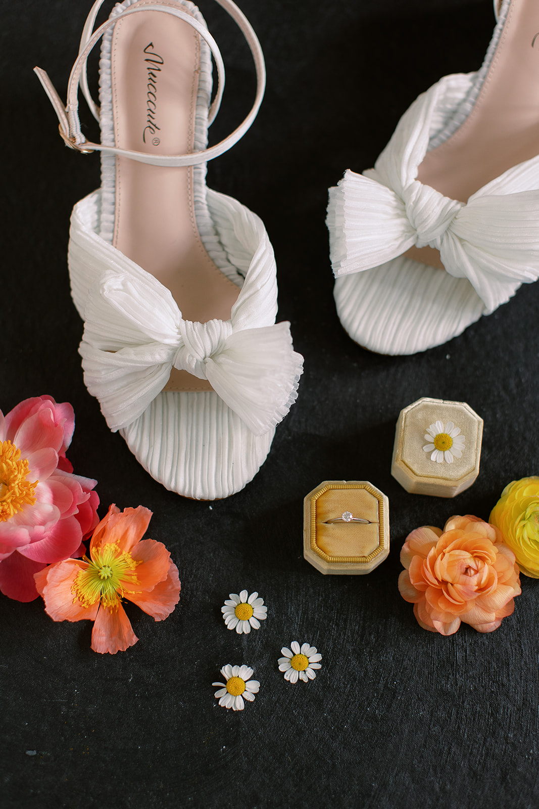 White bridal shoes with bows, bride wedding ring, colorful blooms. Spring wedding in South Carolina, private home, tented. Sarah Bradshaw Photography