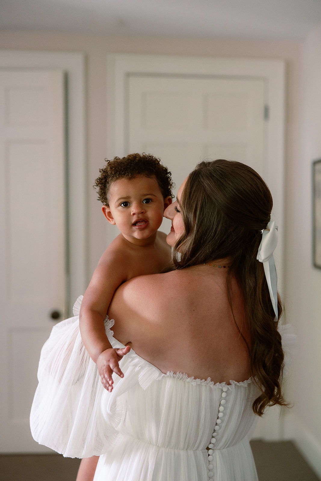 Bride holds daughter on wedding morning. Spring wedding in South Carolina, private home tented wedding. Sarah Bradshaw Photography