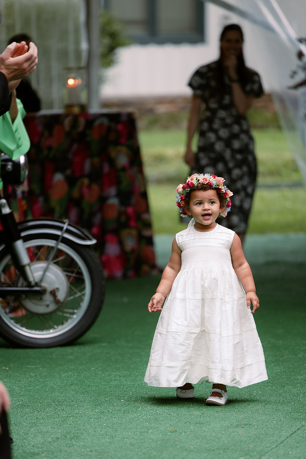 flower girl with flower crown walking down ceremony aisle. spring wedding in south carolina. Sarah Bradshaw Photography