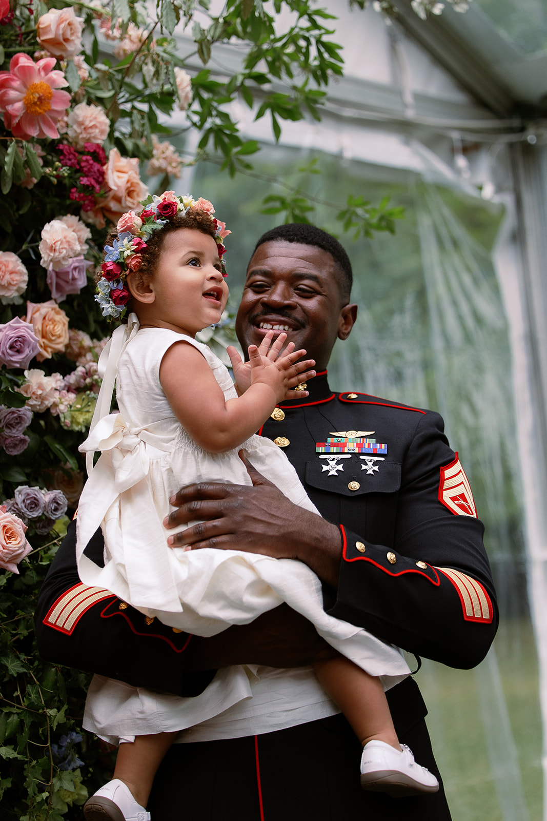 groom holds flower girl daughter at ceremony altar. private tented wedding in south carolina. Sarah Bradshaw Photography