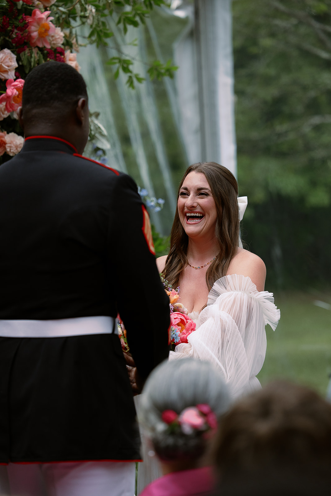 bride laughs during vow exchange. Spring, private home tented wedding in south carolina. Sarah Bradshaw Photography