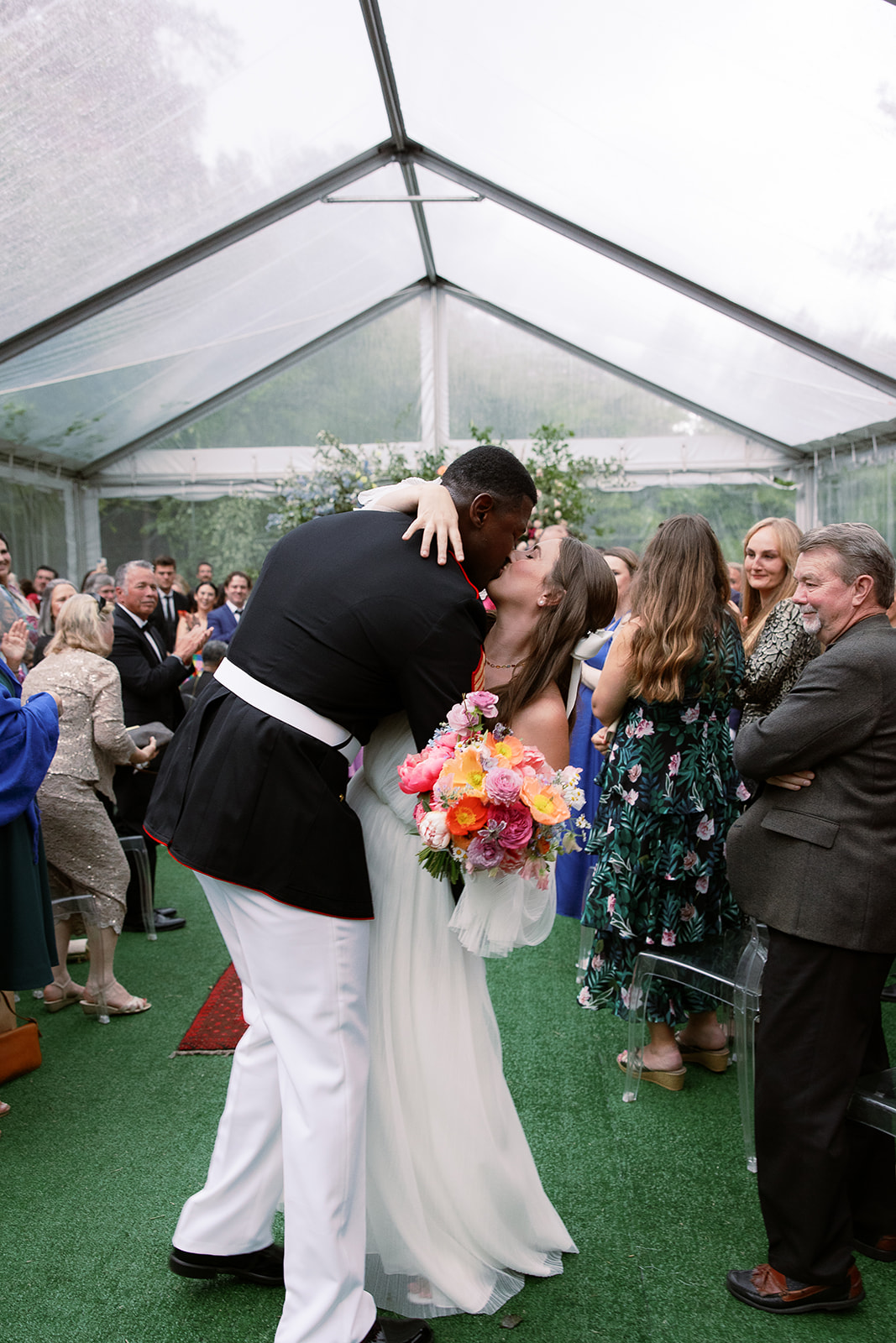 bride and groom kiss when walking down the aisle. Spring, private home tented wedding in south carolina. Sarah Bradshaw Photography
