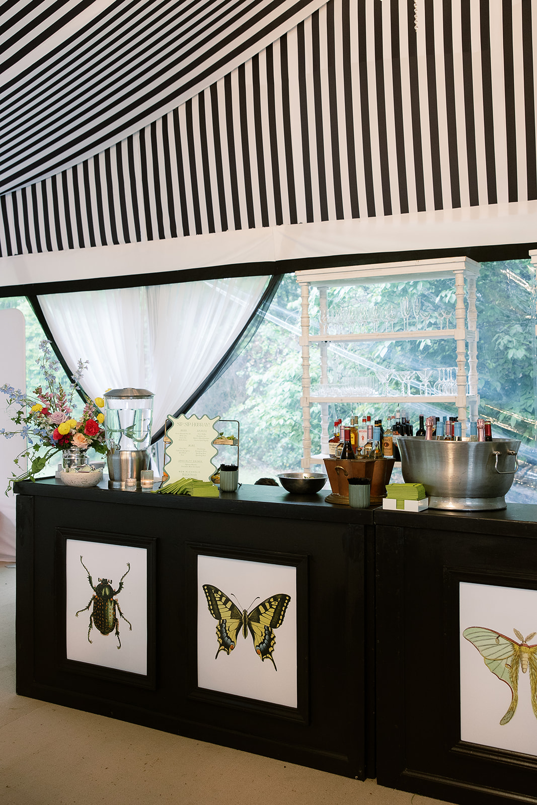 wedding bar with insect paintings. Spring, private home tented wedding in south carolina. Sarah Bradshaw Photography