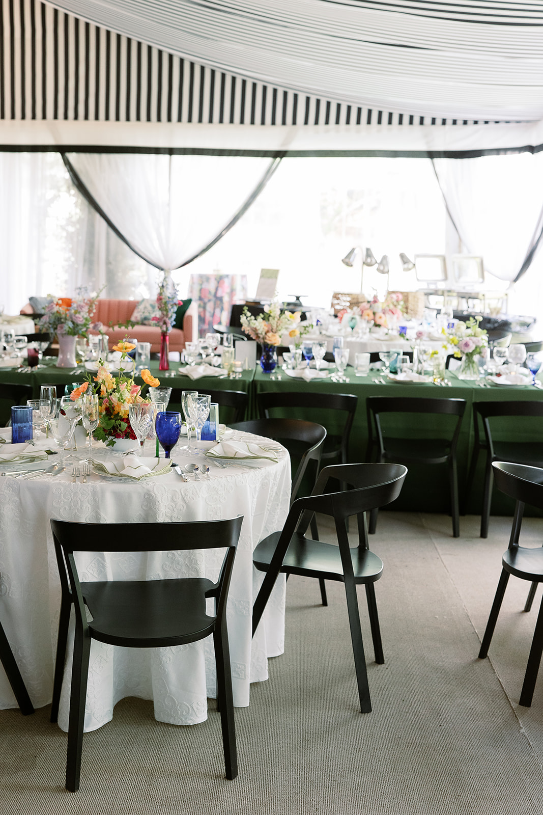 Striped ceiling wedding tent, colorful floral arrangements. Spring, private home tented wedding in south carolina. Sarah Bradshaw Photography