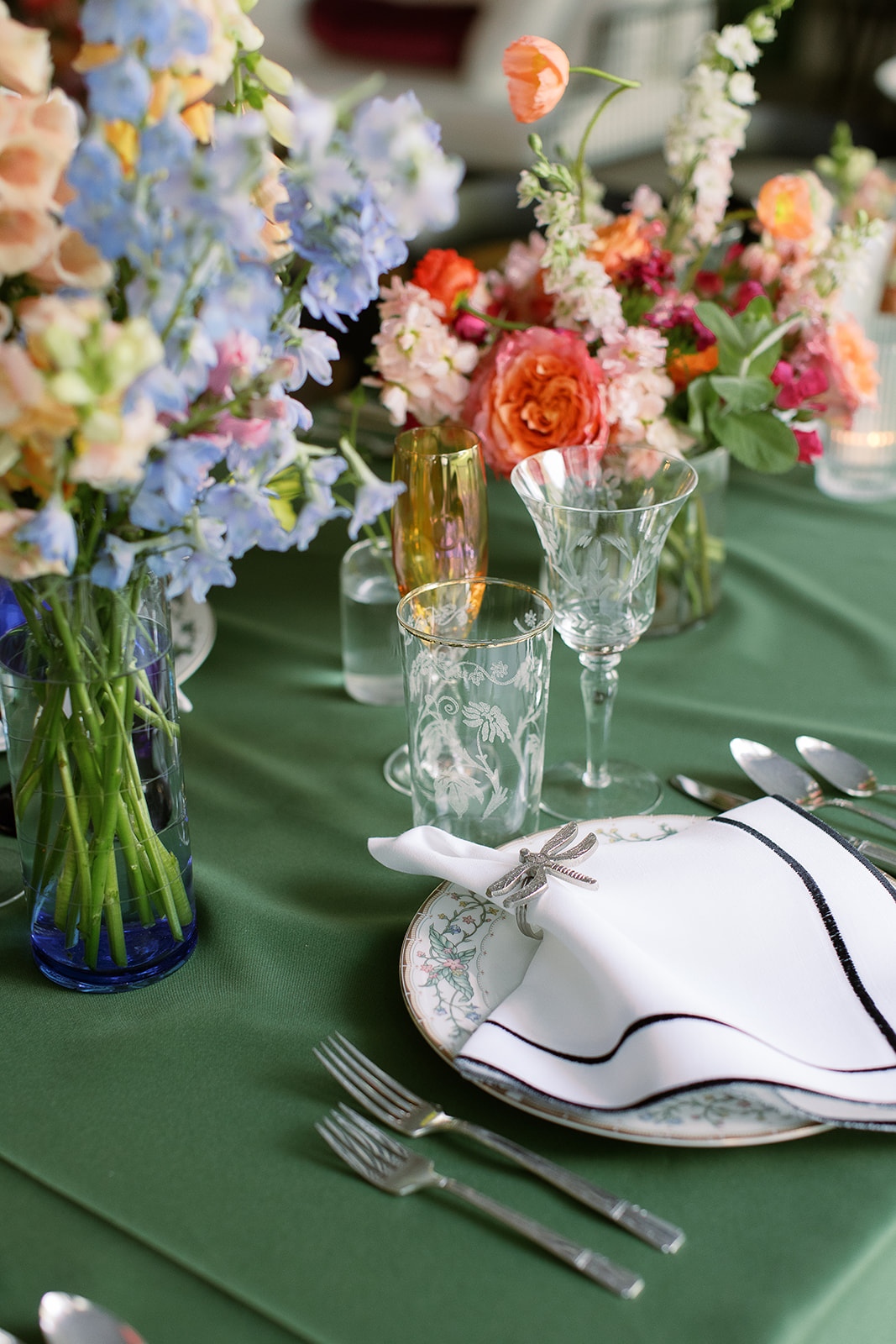 colorful floral centerpieces, green table linens, insect napkin rings. Spring, private home tented wedding in south carolina. Sarah Bradshaw Photography